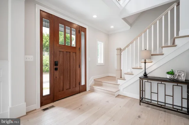 a view of entryway with wooden floor and windows