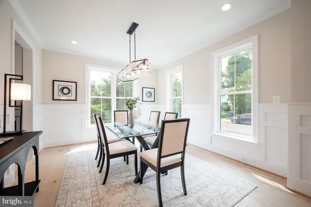 a dining room with furniture a chandelier and window