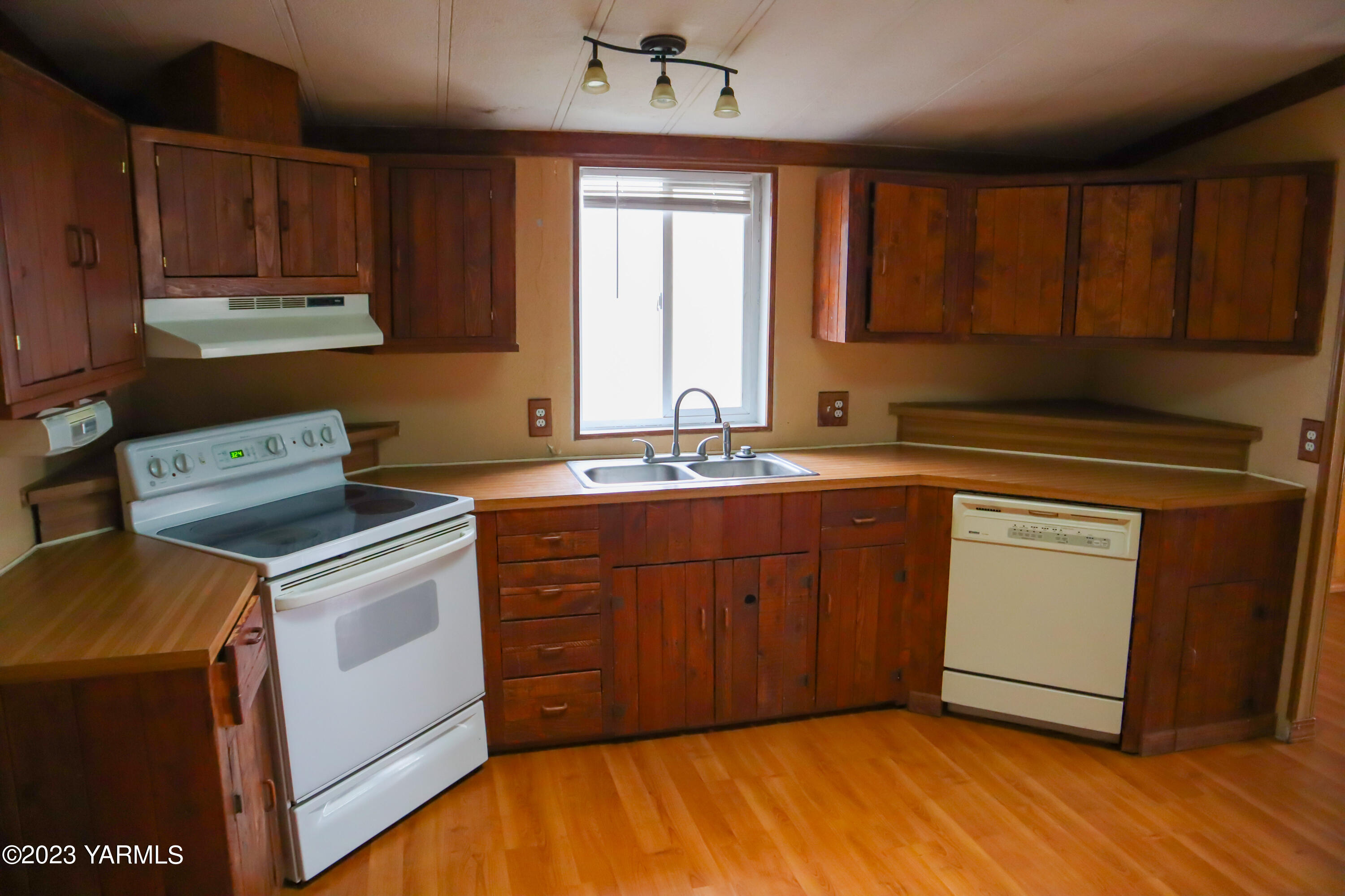 211 Cook Road Yakima, WA 98908 - Photo 6 of 23 a kitchen with a stove sink and cabinets