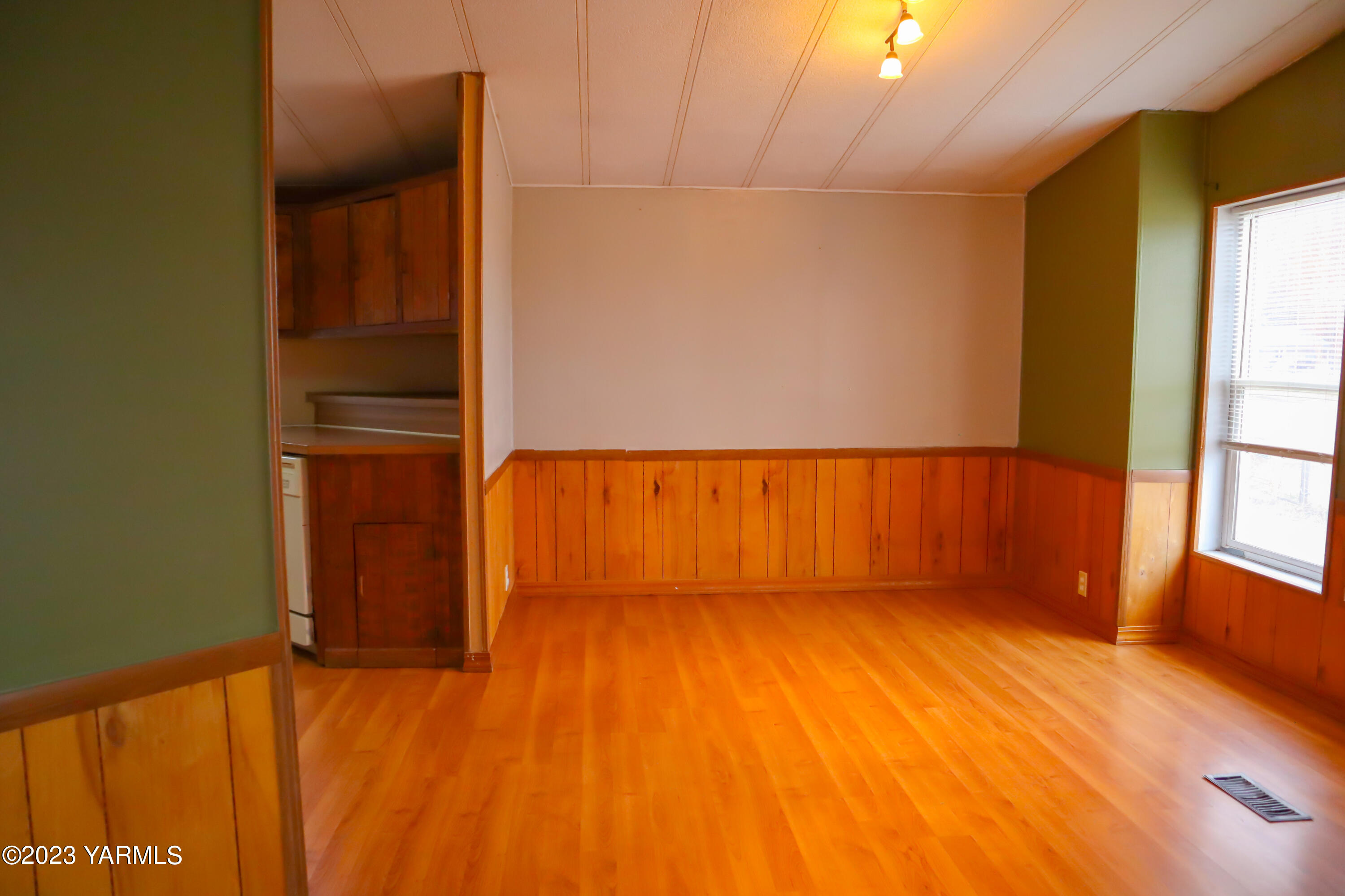 211 Cook Road Yakima, WA 98908 - Photo 8 of 23 an empty room with wooden floor and windows