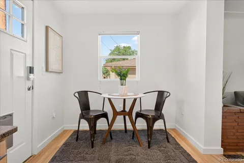 a view of a dining room with furniture window and wooden floor