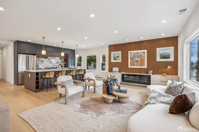 a large living room with stainless steel appliances kitchen island granite countertop a large counter top couches and couches