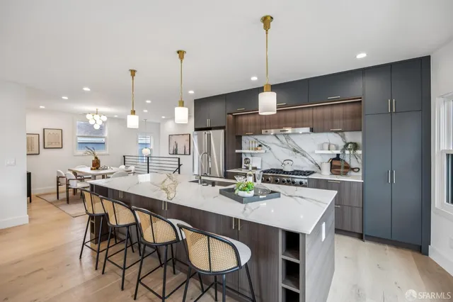 a kitchen with a sink and wooden floor