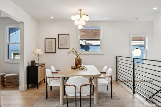 a bathroom with a granite countertop toilet sink mirror and vanity