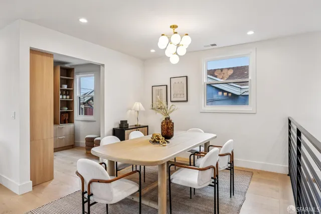 a living room with furniture a mirror and a potted plant