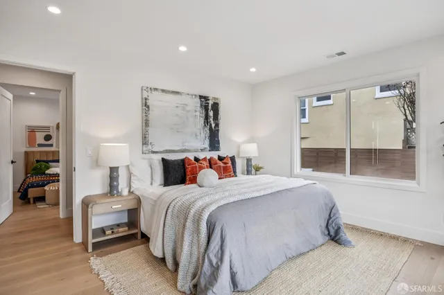 a bedroom with a bed and potted plant