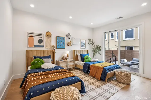 a bedroom with bed and a potted plant
