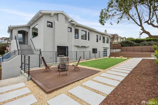 a view of a house with swimming pool and sitting area