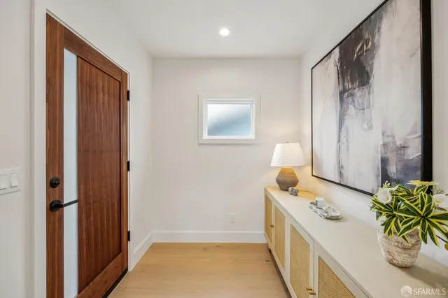 a kitchen with stainless steel appliances granite countertop a table chairs stove and refrigerator