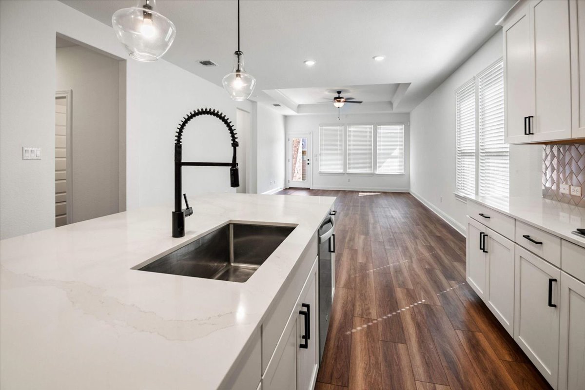 104 Raleigh Drive Georgetown, TX 78633 - Photo 16 of 37 A well-appointed kitchen island offers generous counter space and seamless flow into the inviting living area.