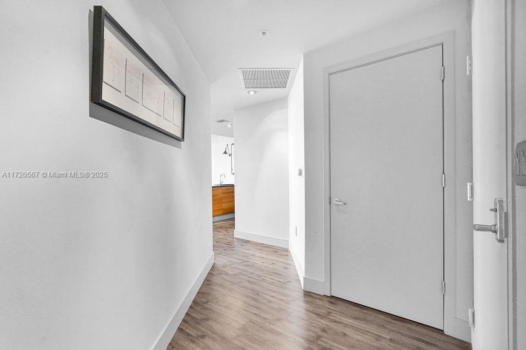 3301 Northeast 1st Avenue, Unit M0404 Miami, FL 33137 - Photo 16 of 68 a view of a hallway with wooden floor and staircase