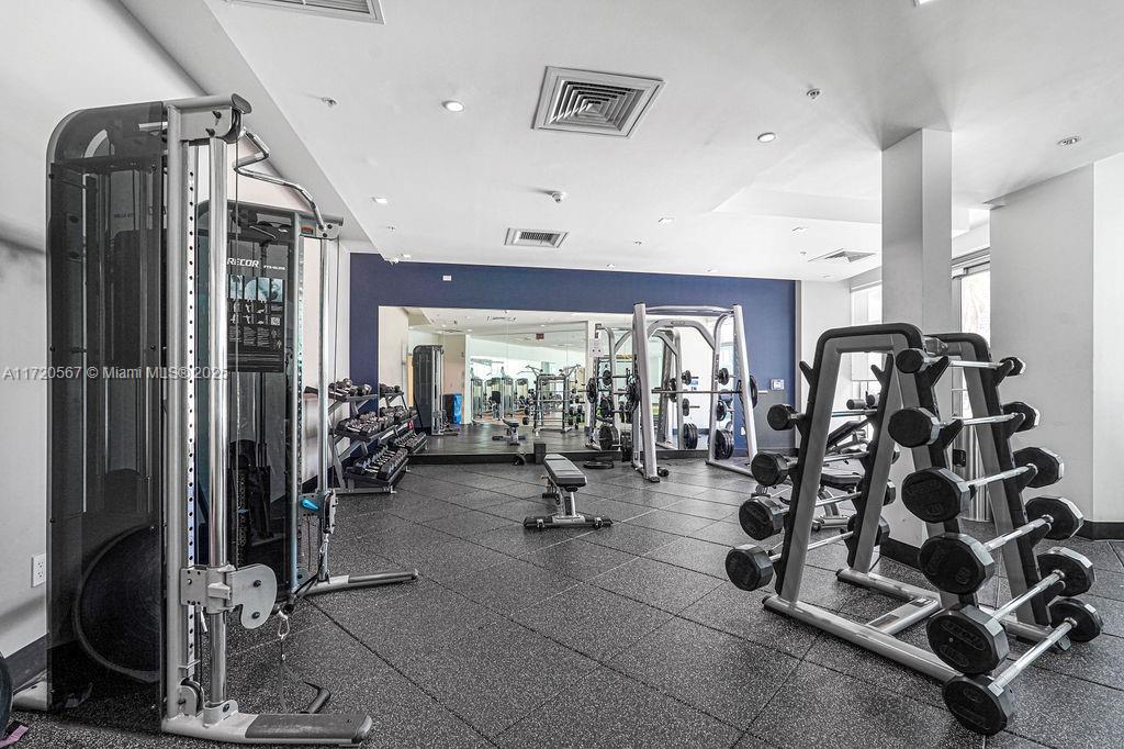 3301 Northeast 1st Avenue, Unit M0404 Miami, FL 33137 - Photo 56 of 68 a room with gym equipment and mirrors