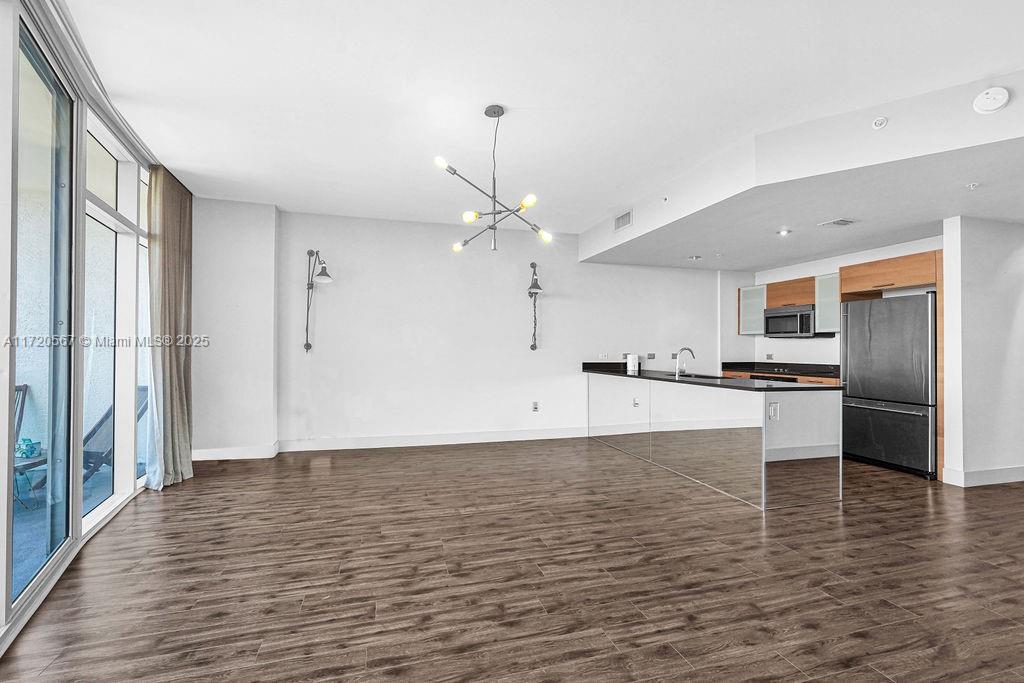 3301 Northeast 1st Avenue, Unit M0404 Miami, FL 33137 - Photo 7 of 68 a view of a kitchen with a refrigerator a stove top oven and kitchen island