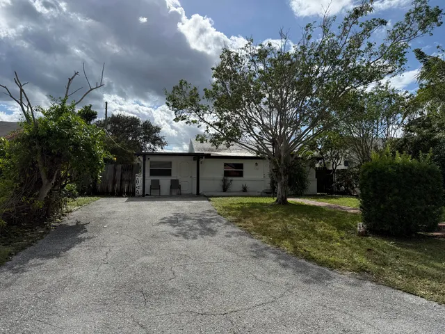 a front view of a house with a yard and a garage