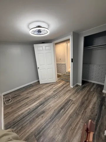 a view of a livingroom with wooden floor and window