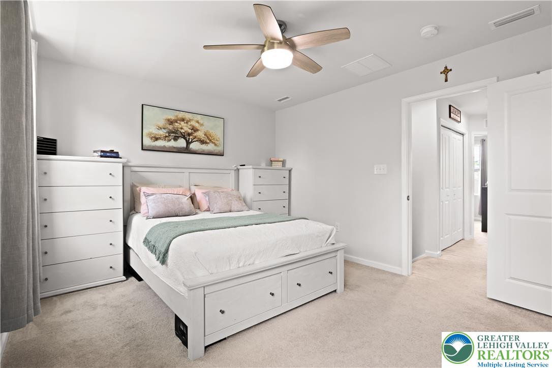 2336 Alex Road Easton, PA 18040 - Photo 12 of 35 The carpeted bedroom features a large bed, several dressers, and a ceiling fan for optimal comfort.