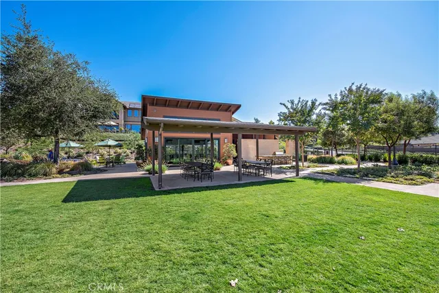 a view of a house with swimming pool and sitting area