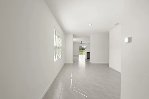 a view of a kitchen and an entryway with a window