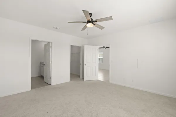 a view of a livingroom with a ceiling fan and window