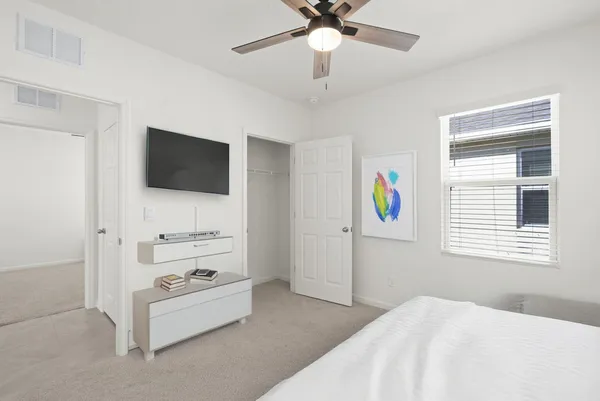 a bedroom with a bed and a flat screen tv