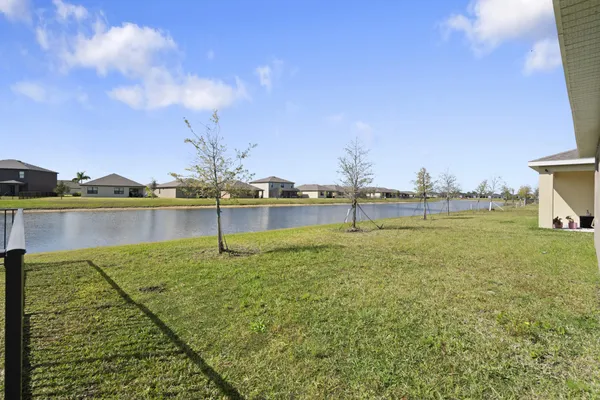 a view of a lake with houses in the back