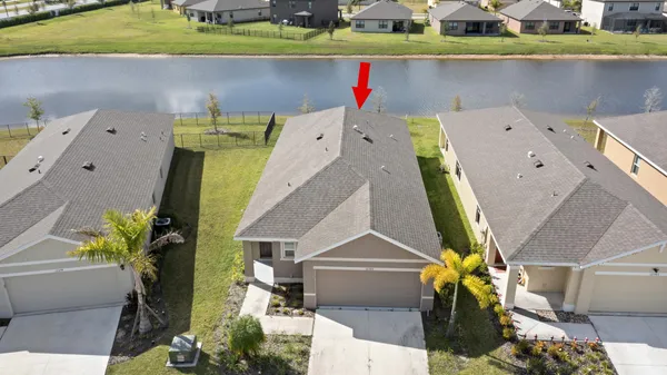 an aerial view of a house with a swimming pool