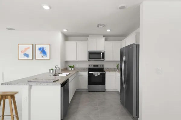 a kitchen with a sink stainless steel appliances and cabinets