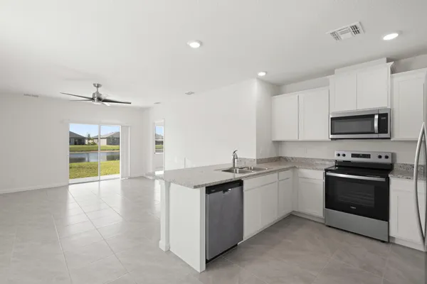a kitchen with stainless steel appliances granite countertop a stove and a sink