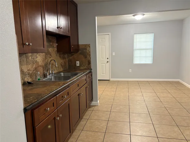 a kitchen with stainless steel appliances granite countertop a stove a sink and a granite counter tops