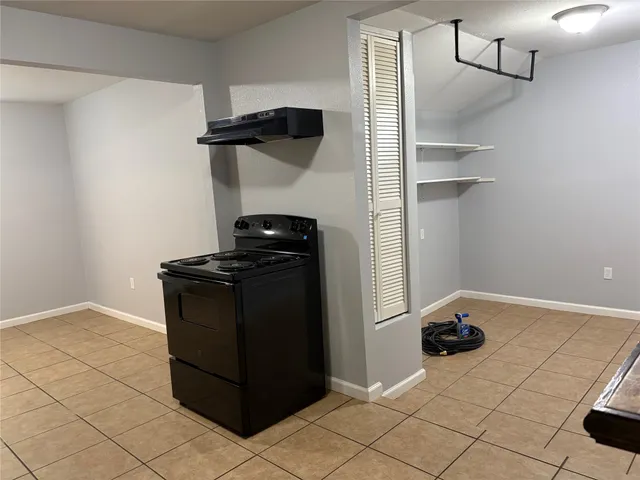 a kitchen with a refrigerator and a stove