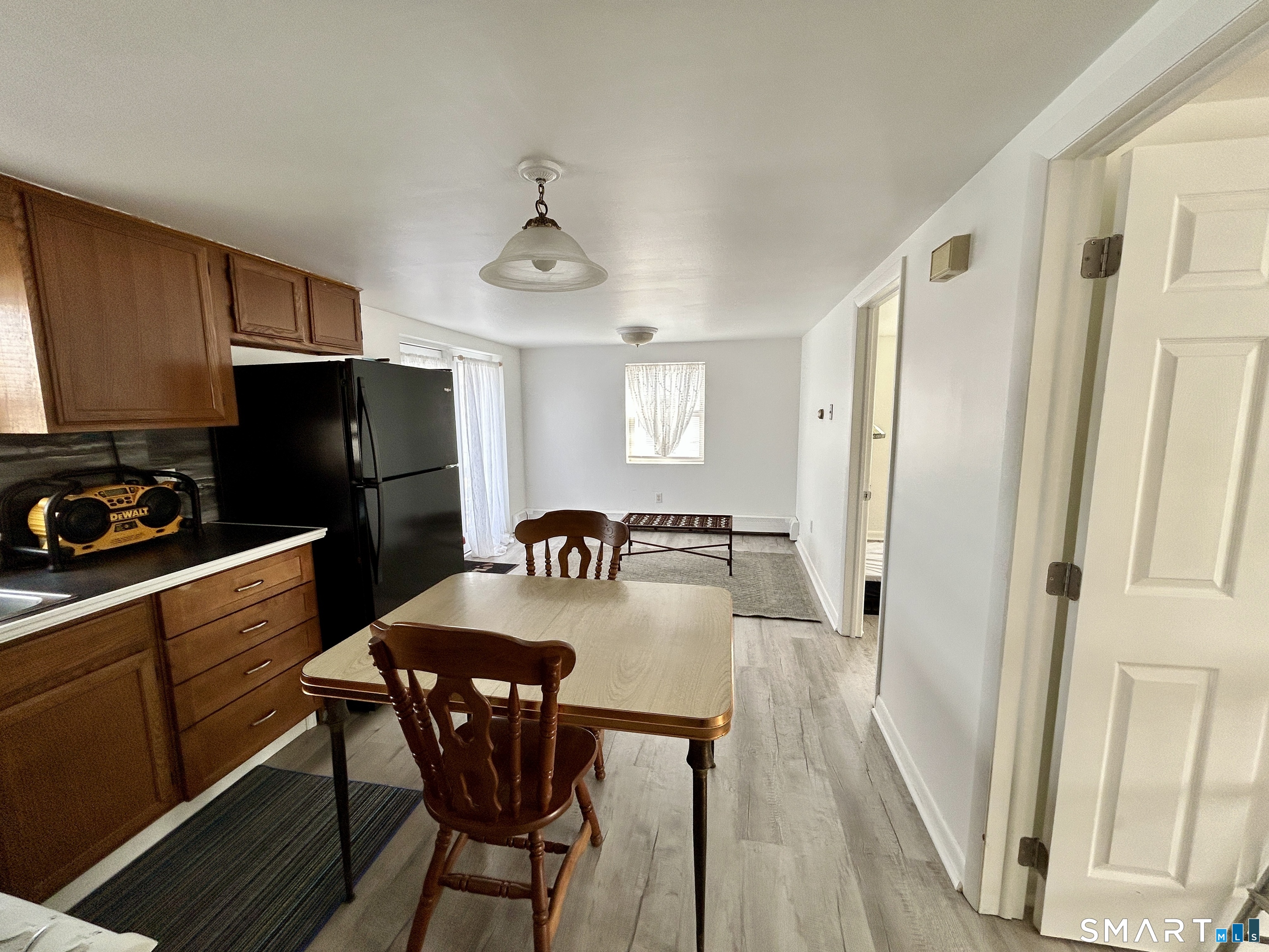 Portland Street Middletown, CT 06457 - Photo 12 of 20 a kitchen with stainless steel appliances a dining table chairs refrigerator and sink