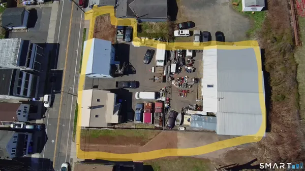an aerial view of a house with parking space