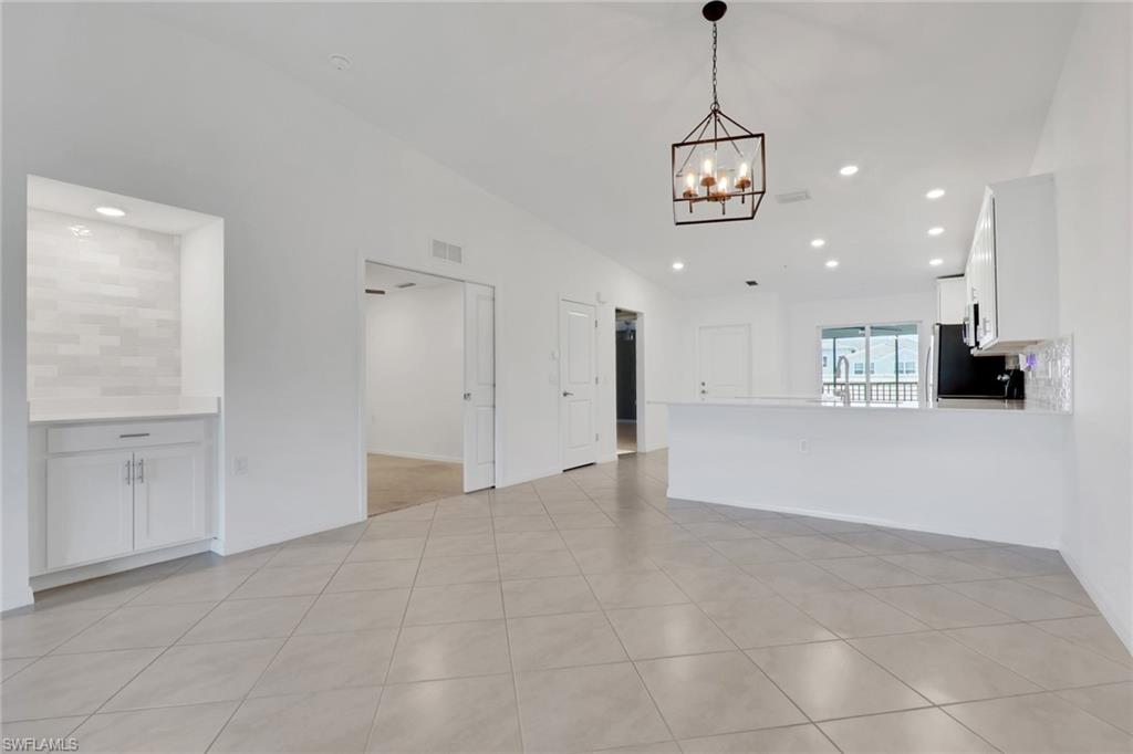6047 Ellerston Way, Unit 2125 Ave Maria, FL 34142 - Photo 11 of 41 Living room, den, and dining room, with breakfast bar