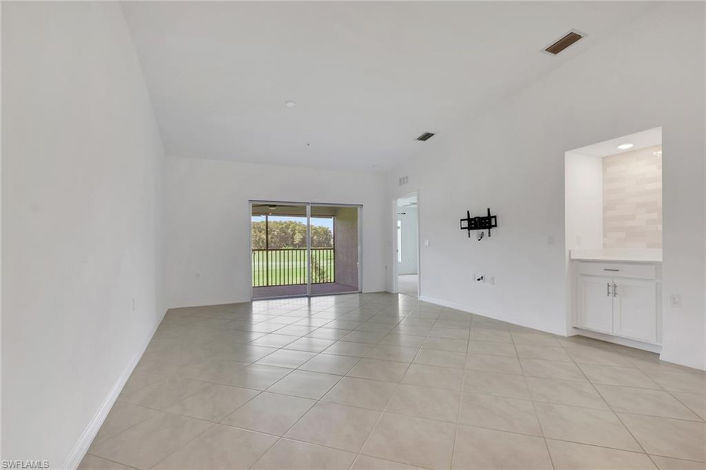 6047 Ellerston Way, Unit 2125 Ave Maria, FL 34142 - Photo 15 of 41 Living room with built-in tiled coffee bar