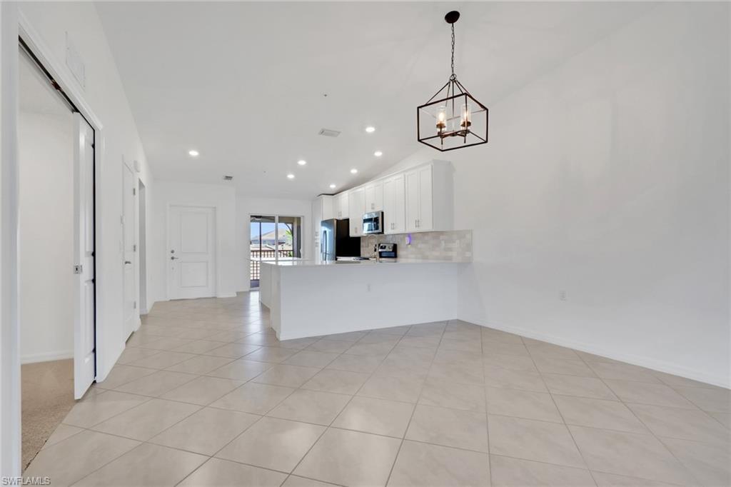 6047 Ellerston Way, Unit 2125 Ave Maria, FL 34142 - Photo 10 of 41 Dining area, living room and entry to den area