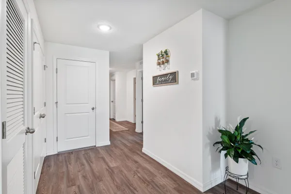 a view of a hallway with wooden floor and table