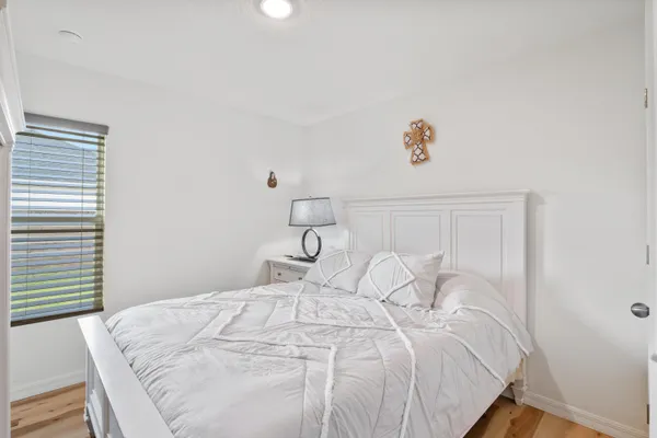 a bedroom with a white bed and a cabinets