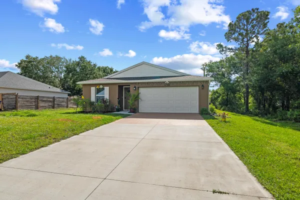 a front view of house with yard and green space