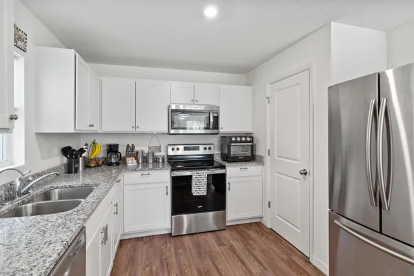 a kitchen with a refrigerator stove and sink