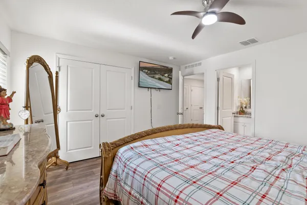 a bedroom with a bed and a chandelier