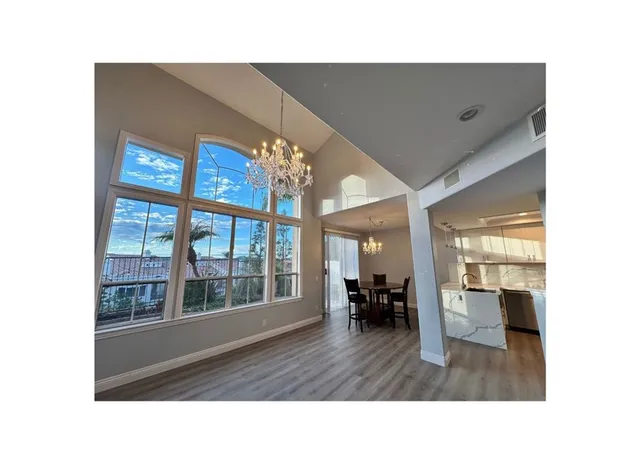 a hallway with couches and a potted plant