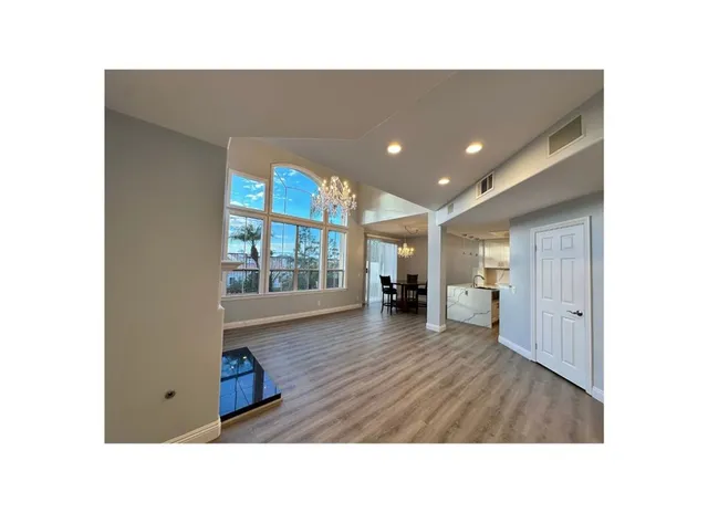 a living room with stainless steel appliances kitchen island granite countertop furniture and a view of kitchen