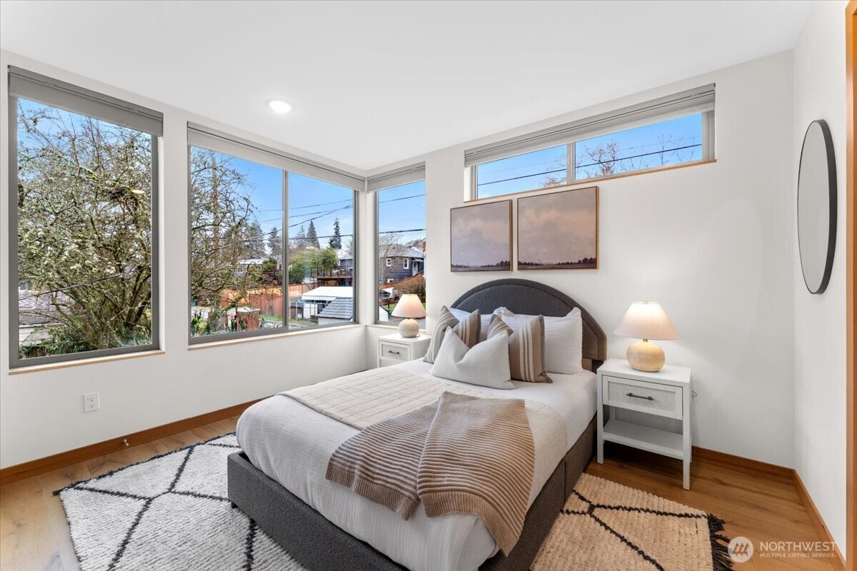 5017 Fauntleroy Way Southwest, Unit B Seattle, WA 98136 - Photo 16 of 24 a bedroom with a bed and window