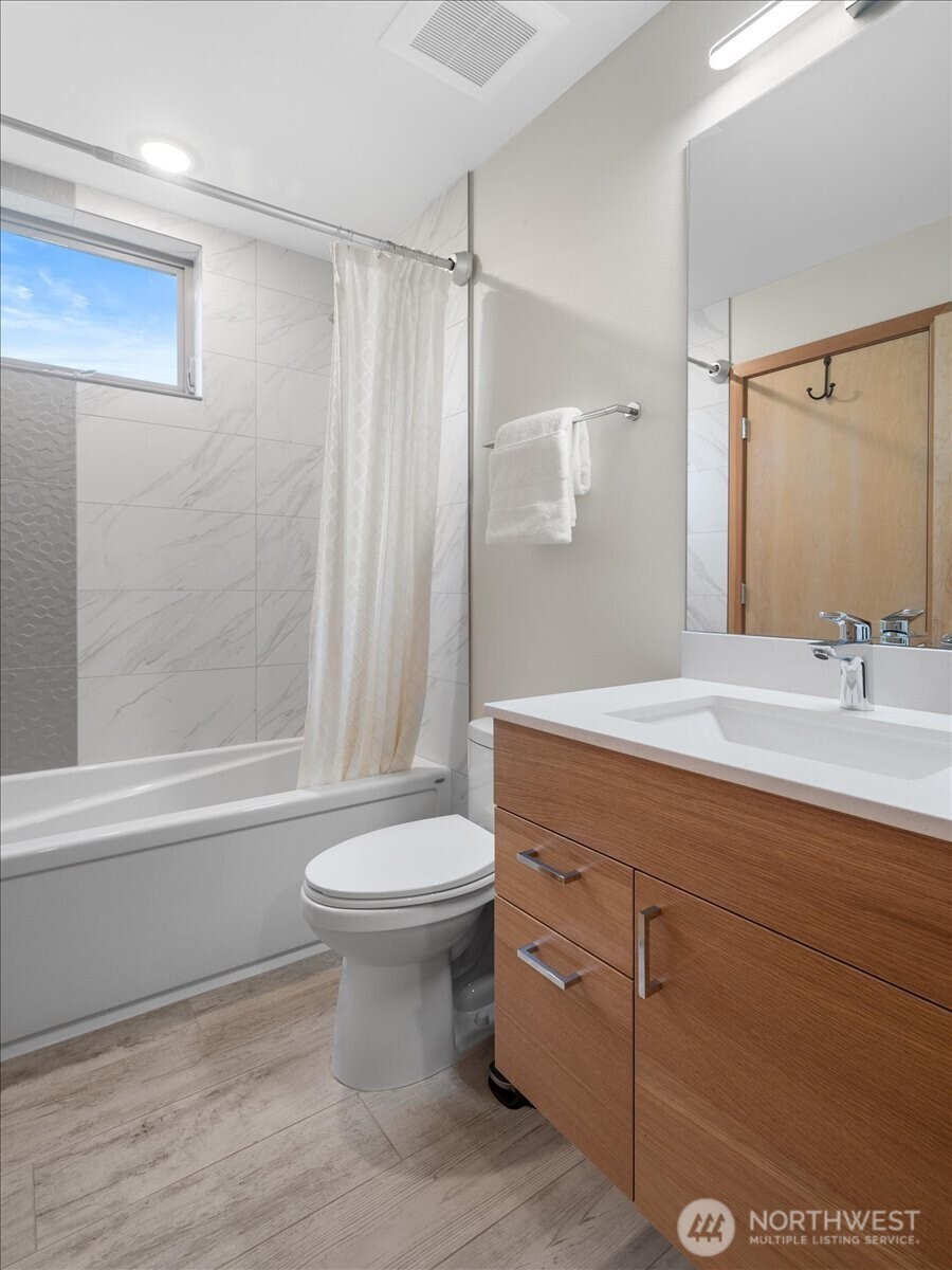 5017 Fauntleroy Way Southwest, Unit B Seattle, WA 98136 - Photo 19 of 24 a bathroom with a sink a toilet and shower