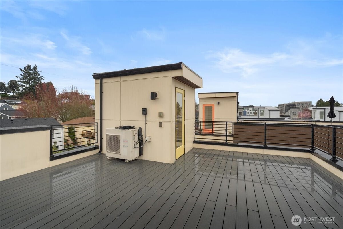 5017 Fauntleroy Way Southwest, Unit B Seattle, WA 98136 - Photo 21 of 24 a view of a terrace with wooden floor and fence