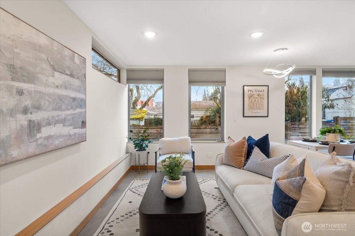 5017 Fauntleroy Way Southwest, Unit B Seattle, WA 98136 - Photo 4 of 24 a living room with furniture couches and large windows with garden view