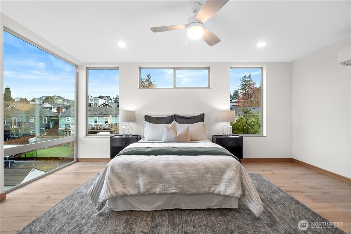 5017 Fauntleroy Way Southwest, Unit B Seattle, WA 98136 - Photo 10 of 24 a spacious bedroom with a bed and a large window