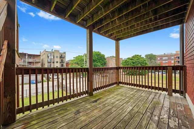 a view of a balcony with wooden floor