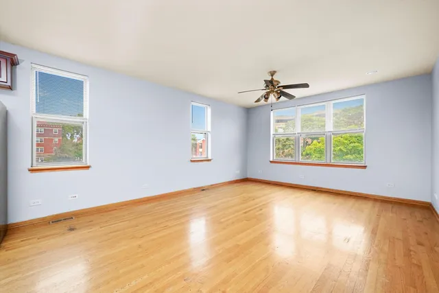 a view of a room with a window and a ceiling fan