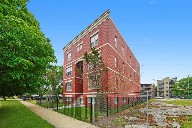 a view of a large building next to a yard